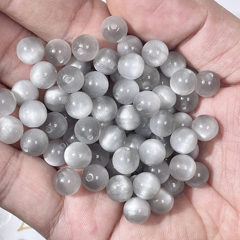Cat Eye Resin Beads - Gray shimmer beads in hand